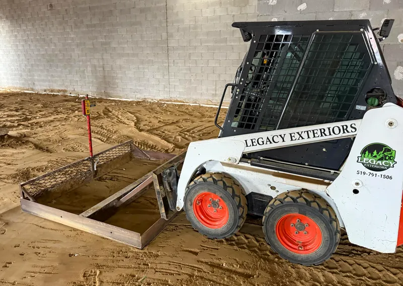 Bobcat machine grading a construction site