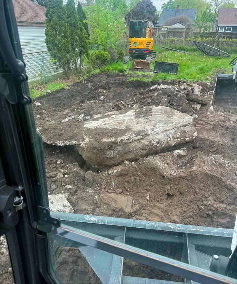 Breaking up a buried concrete slab during backyard excavation