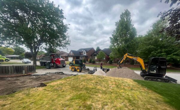Legacy Exteriors Inc removing old driveway for replacement.